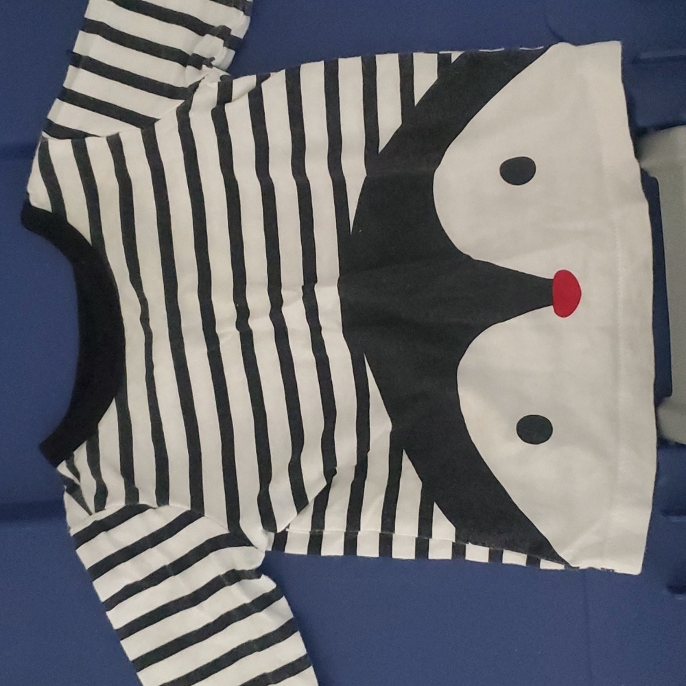 Used 3-6 month long sleeve black and white penguin with stripes